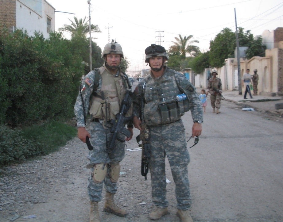 Hegseth poses with a fellow soldier in uniform. 