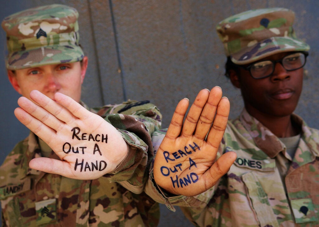 Army Sgt. Rebecca Landry and Spc. Asia Jones highlight the importance of suicide prevention and awareness at Camp Taji, Iraq, June 5, 2019. 