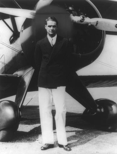 Howard Hughes in front of a sea plane