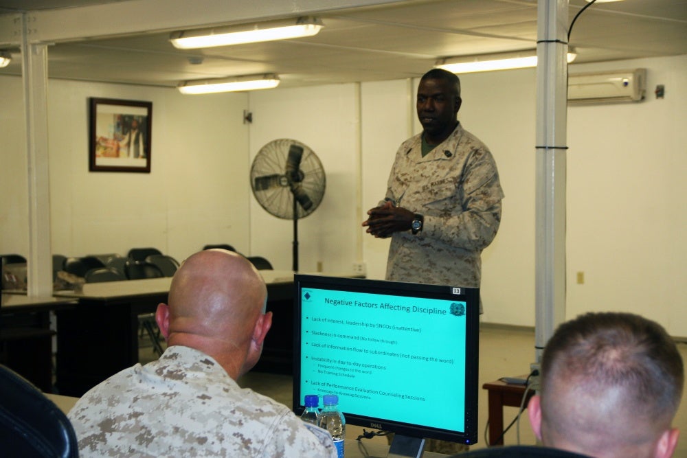 Soldier giving powerpoint presentation, Pretend to be dumb to avoid these