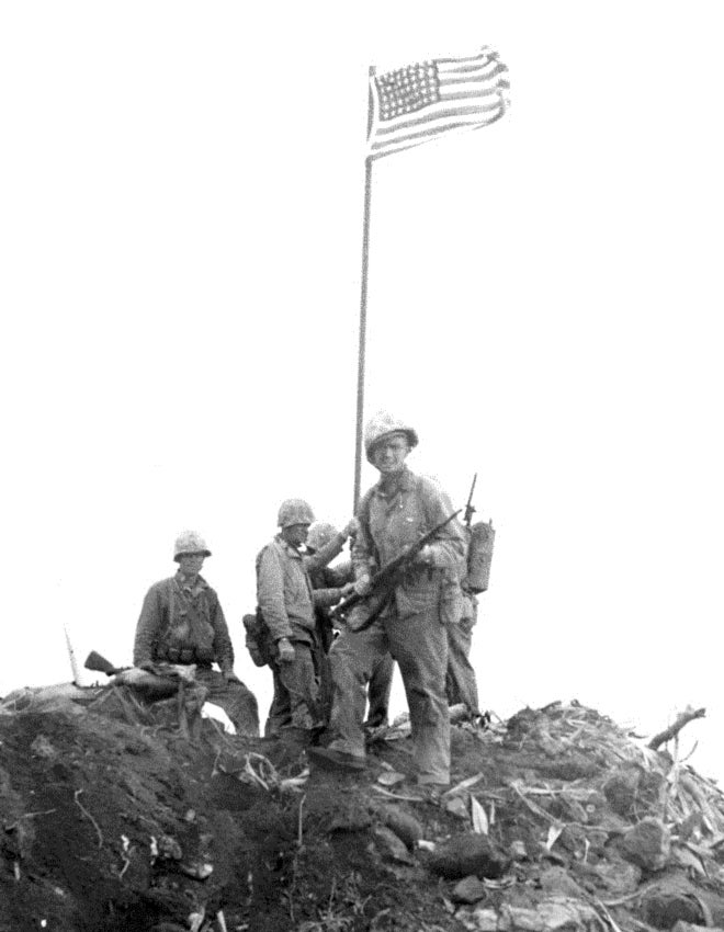 Detail of a photograph of the first flag-raising on Iwo Jima, showing Ernest Ivy Thomas Jr. in the foreground, facing the viewer. The subject of the photograph is identified in the article "Another View of the Iwo Flag Raisings" by Robert L. Sherrod, appearing in Fortitudine, Vol. X No. 3, Winter 1980–1981 