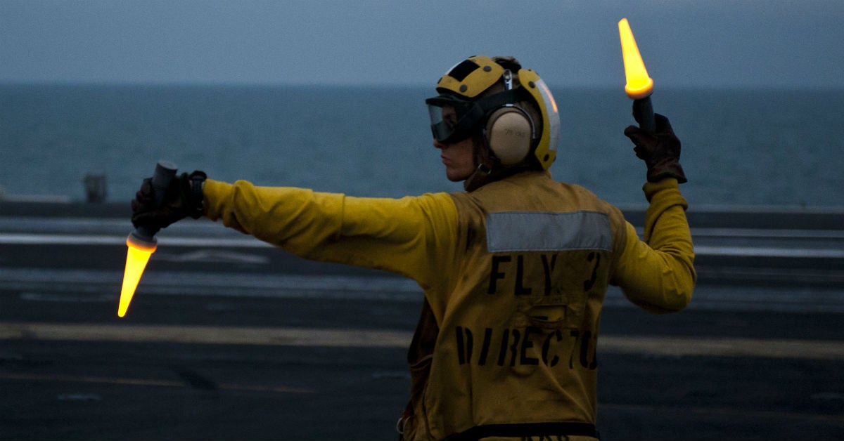 navy specialist in yellow shirt