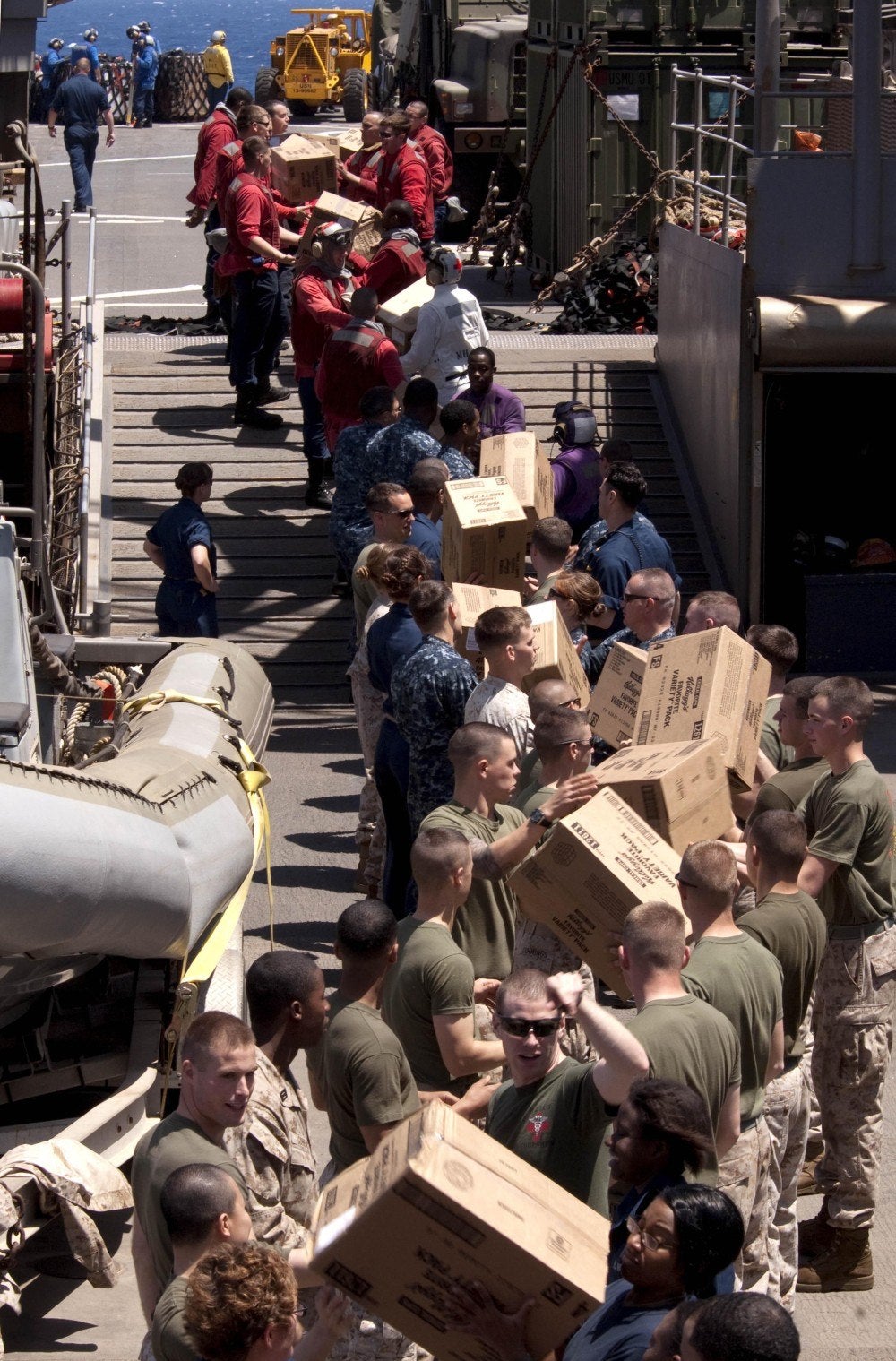 Navy men receiving packages after UNREP