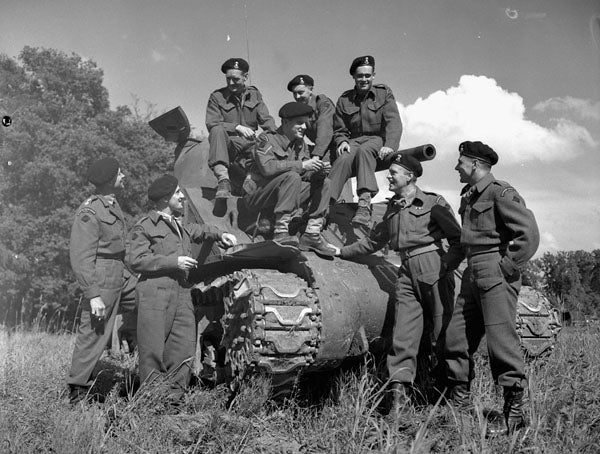 Crewmembers sitting on the surviving tank