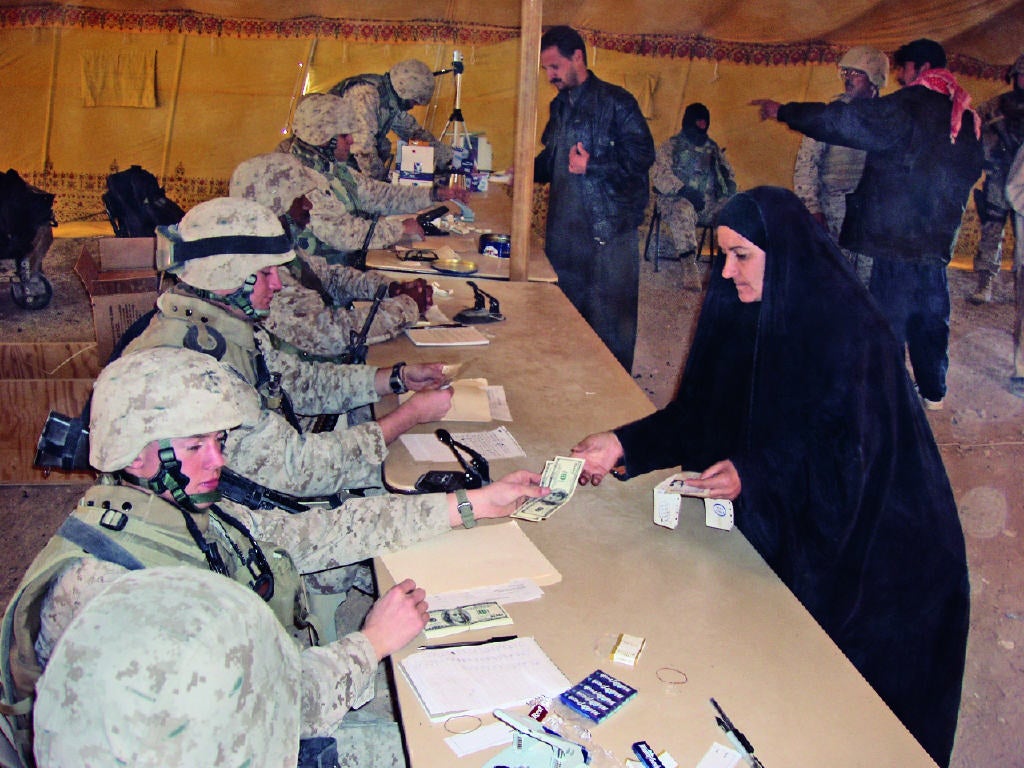  Marines paying displaced civilians $200 as they return to Fallujah. (Photo courtesy of J. Kael Weston)