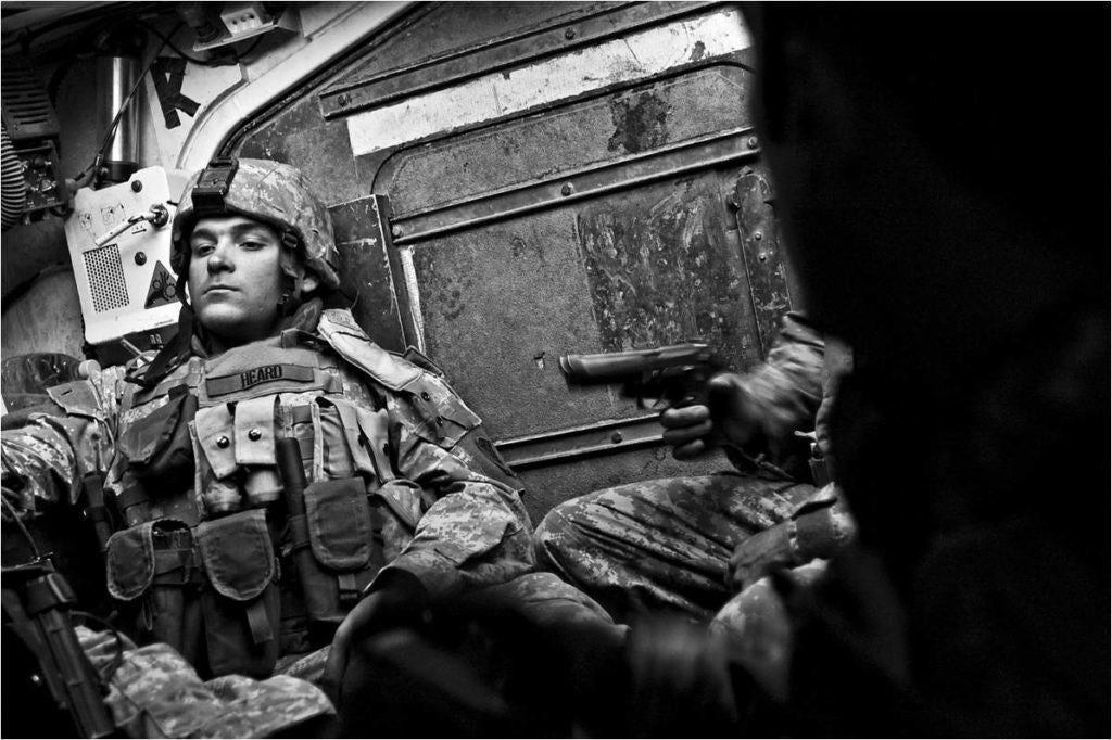 An image Putnam took as a civilian photographer, of a soldier inside a combat vehicle