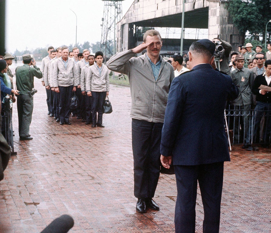  American POWs held in Vietnam being returned to U.S. military control at Gia Lam airfield, Hanoi. In foreground facing camera is USAF Capt. Robert Parsels. (U.S. Air Force photo)