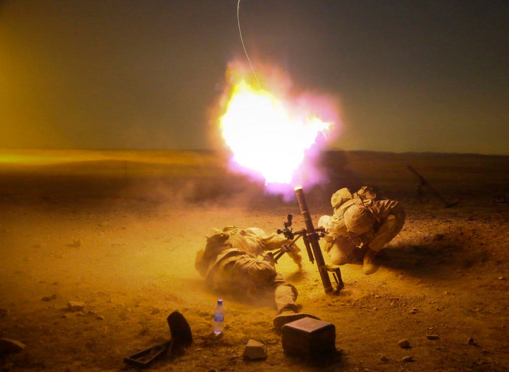Marine brigade firing a weapon