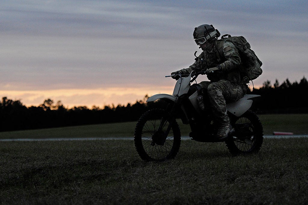  An Air Force Special Tactics airman surveys a remote landing strip in his offroad motorcycle. (Photo from U.S. Air Force)