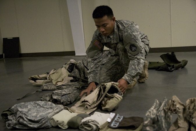 A soldier packs clothes for an upcoming mission. Extra layers are #1 on our list of useful gear. 