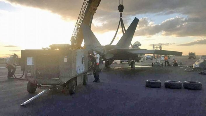 An F-22 pilot makes a gear-up belly landing after losing power