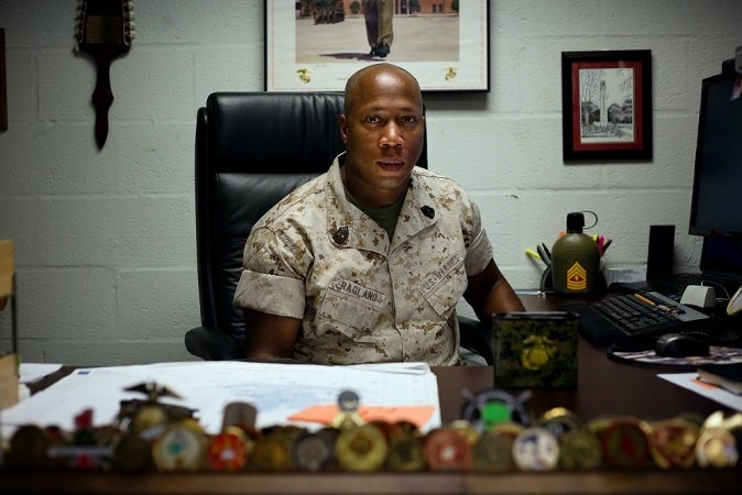 A quiet drill sergeant sits behind a desk