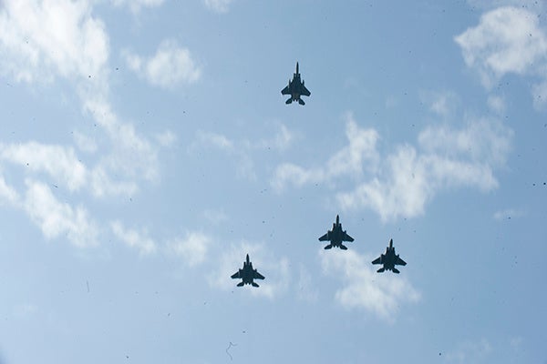 Four F-15E Strike Eagles conduct a missing man formation