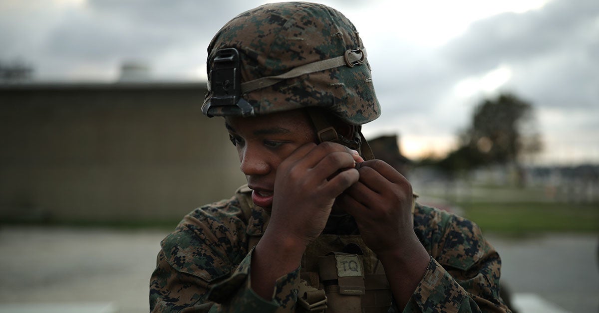 A soldier putting a helmet to the test. Some helmets can stop bullets