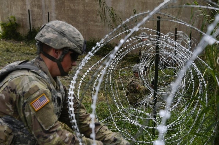 US troops are laying miles of razor wire on the border