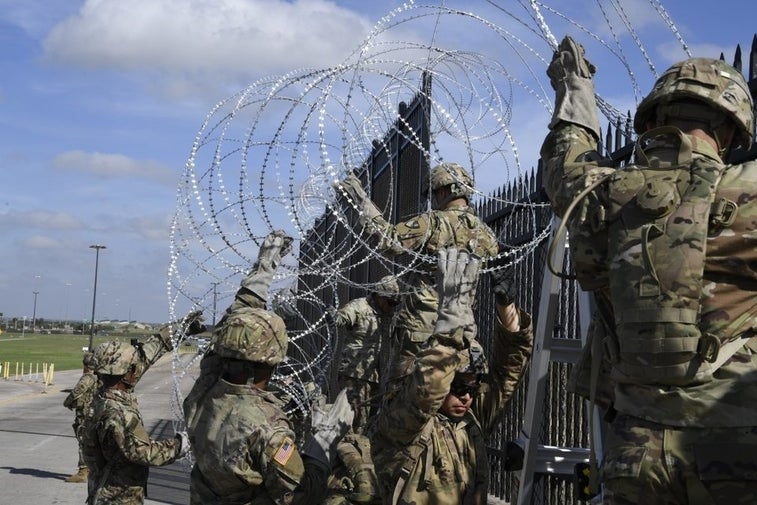 US troops are laying miles of razor wire on the border