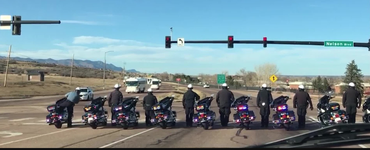 Watch police stop the world to salute troops coming home from Afghanistan