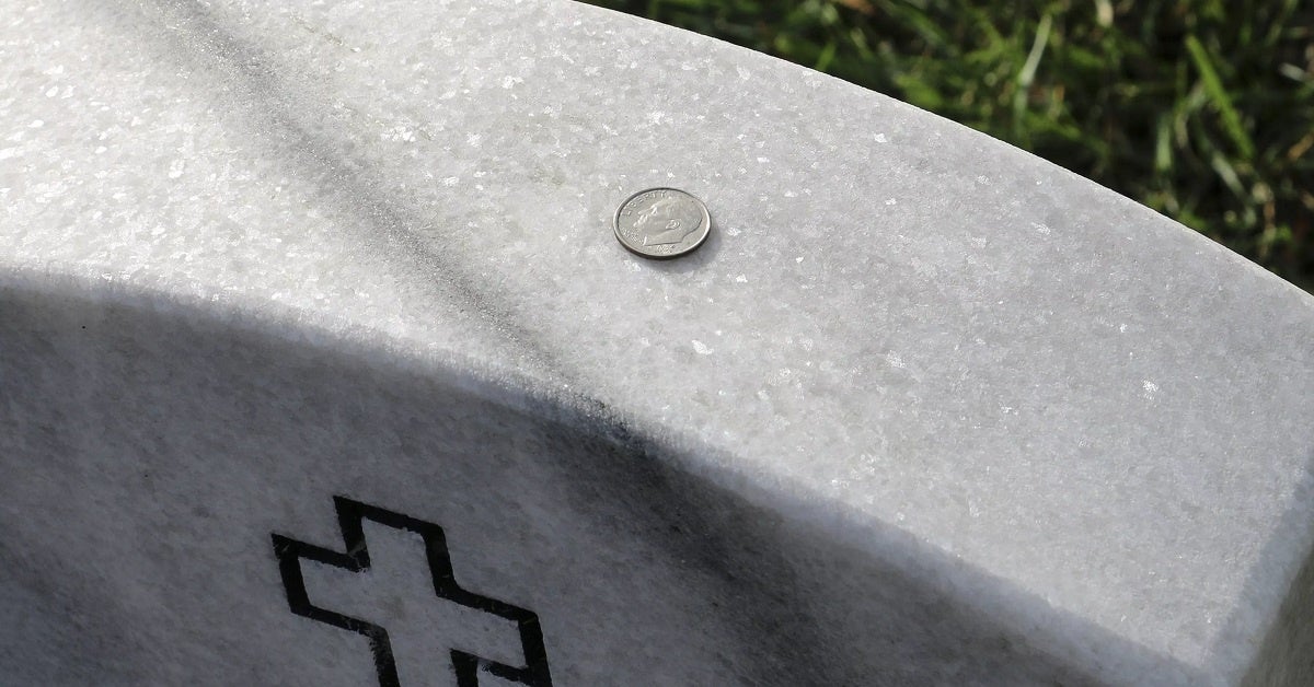 What happens to coins on military headstones?