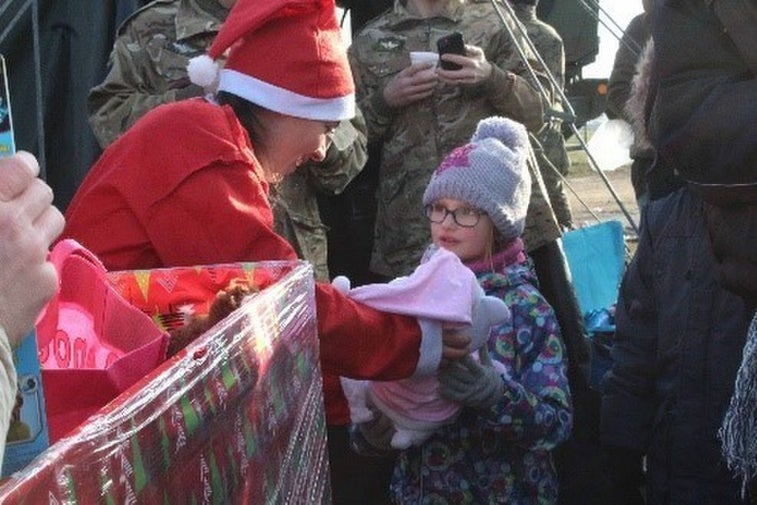 Paratroopers jump with Santa Claus and gift presents to kids