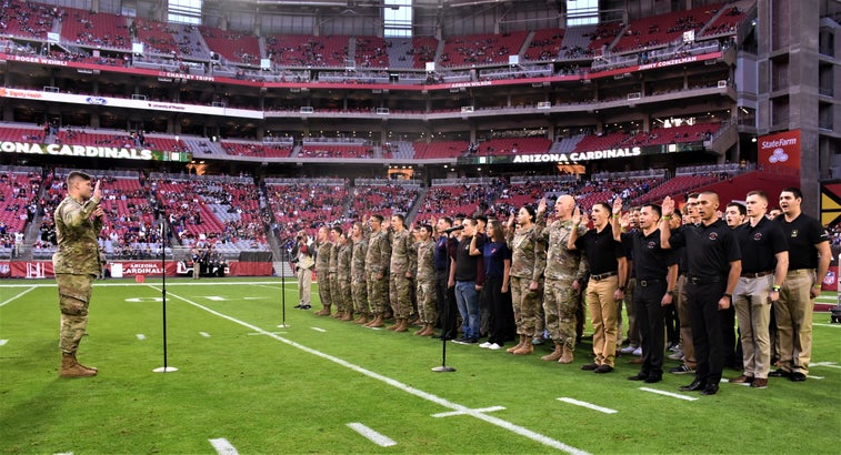 An NFL player and West Pointer reenlisted troops before the Cardinals-Rams game