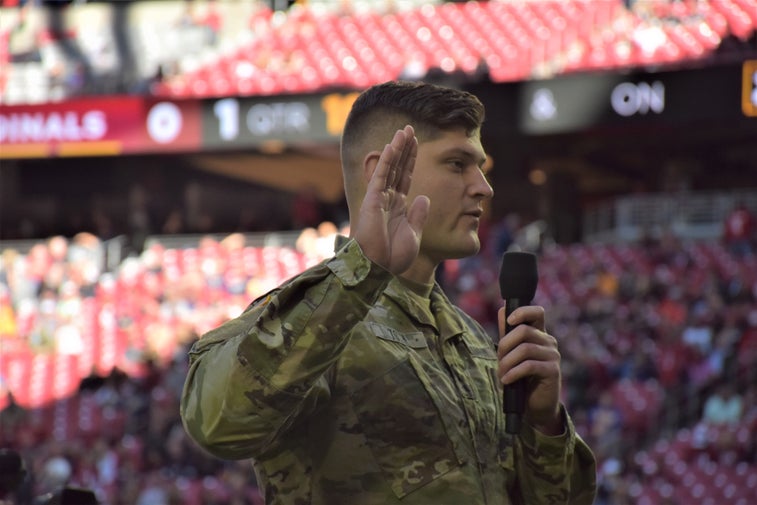 An NFL player and West Pointer reenlisted troops before the Cardinals-Rams game