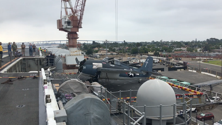 This modern amphibious assault ship is carrying WWII planes