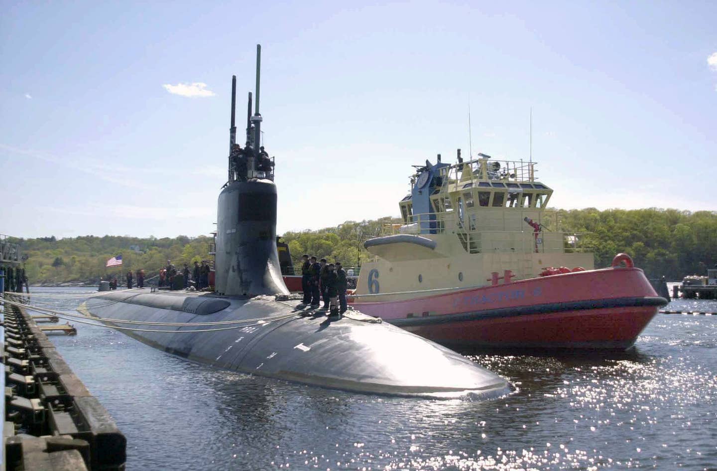 A Starboard bow view of the US Navy (USA) Seawolf Class Submarine, USS CONNECTICUT (SSN 22), showing Sailors standing on deck as the nuclear-powered attack submarine prepares to depart its homeport at Submarine Base New London, located at Groton, Connecticut (CT), for its first scheduled deployment.
