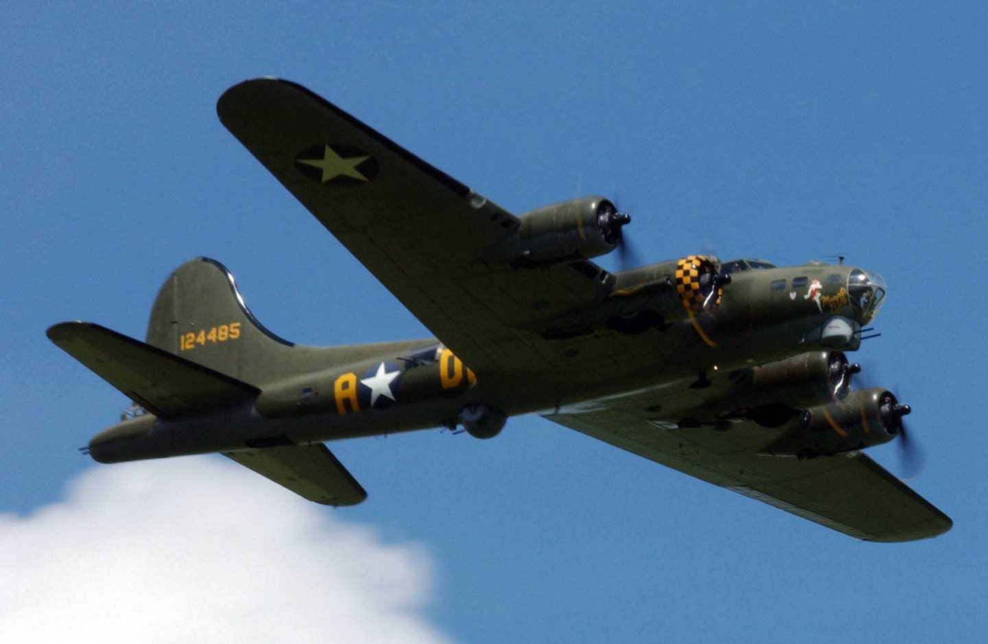 The "Sally B" B-17 Flying Fortress bomber aircraft flies overhead during the Memorial Day ceremony held at the Madingley American Cemetery near the city of Cambridge, England (ENG), in honor of the World War II fallen.