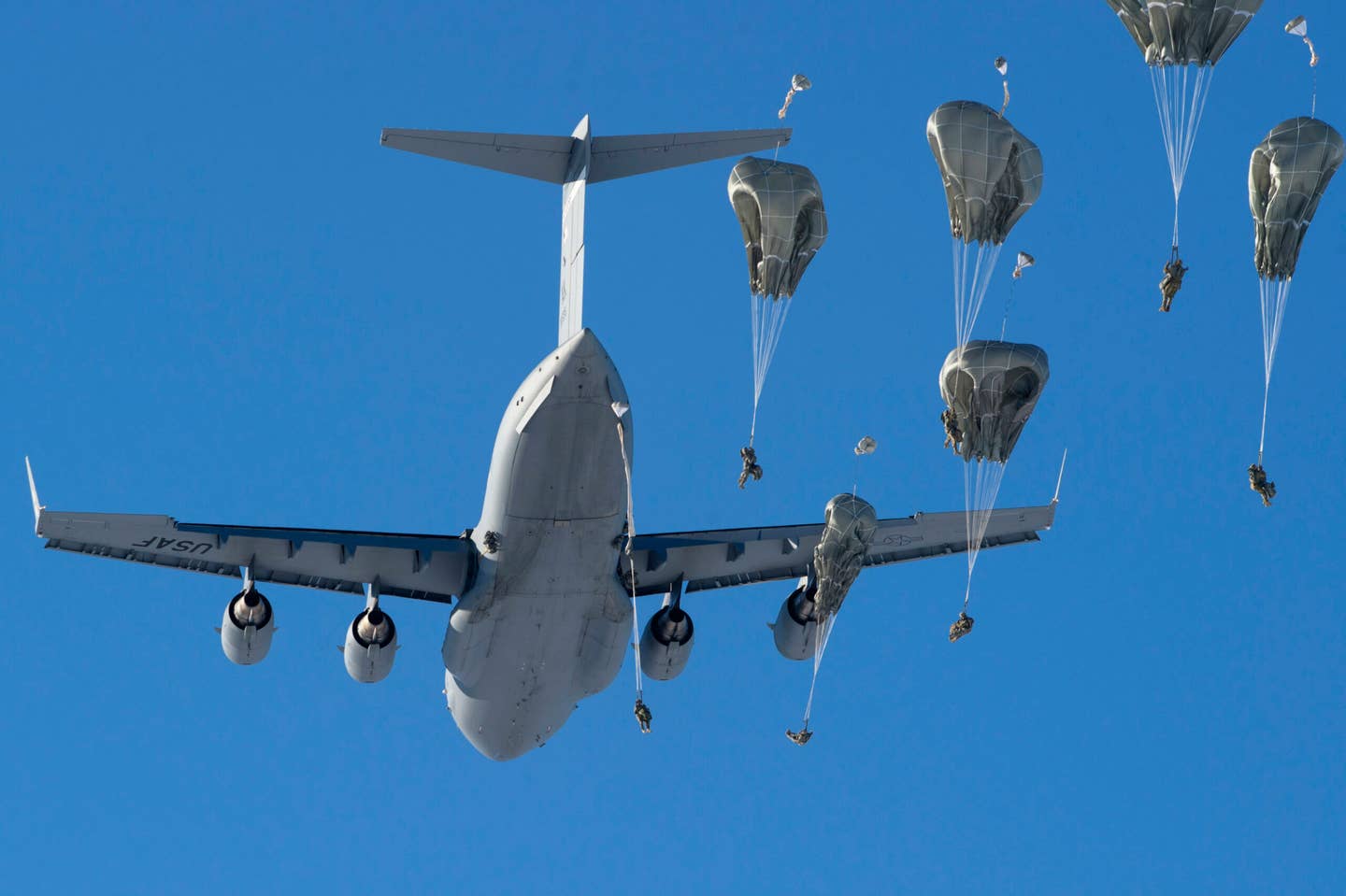 U.S. Army paratroopers assigned to the 4th Infantry Brigade Combat Team (Airborne), 25th Infantry Division, U.S. Army Alaska, jump from an Air Force C-17 Globemaster III with the 3rd Wing during airborne training over Malemute Drop Zone, Joint Base Elmendorf-Richardson, Alaska, March 22, 2018. The Soldiers of 4/25 belong to the only American airborne brigade in the Pacific and are trained to execute airborne maneuvers in extreme cold weather/high altitude environments in support of combat, training and disaster relief operations. (U.S. Air Force photo by Alejandro Peña)