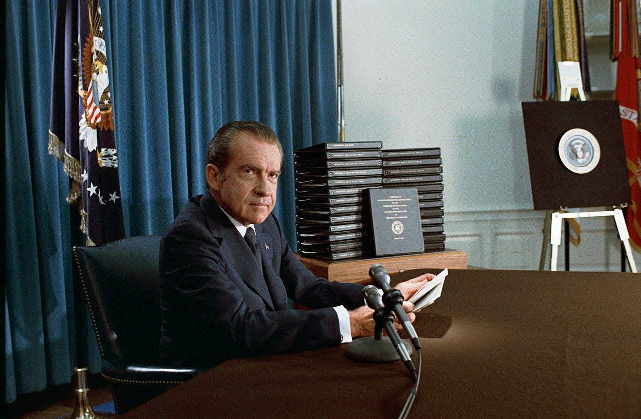 President Richard Nixon near Stacks of White House Tapes Transcripts Recording a National Radio/Television Announcement, April 22, 1974. (The Nixon Library)