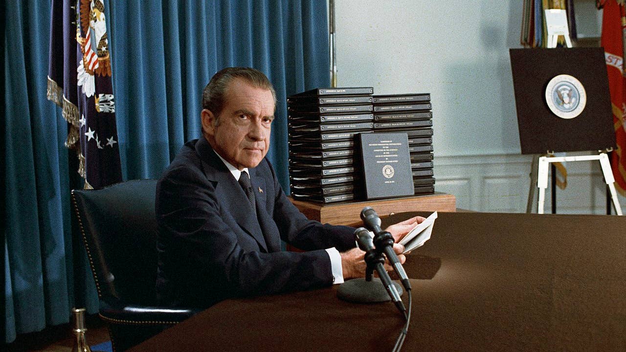 President Richard Nixon near Stacks of White House Tapes Transcripts Recording a National Radio/Television Announcement, April 22, 1974. (The Nixon Library)