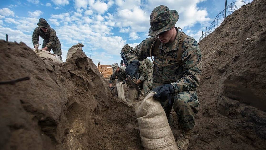 Marines assigned to Marine Wing Support Squadron 271, Marine Aircraft Group 14, 2nd Marine Aircraft Wing fill sand bags during a field exercise aboard Marine Corps Auxiliary Landing Field Bogue, N.C., Nov. 30, 2016. MWSS-271 conducted a two-week field exercise that focused on maintaining the squadron's expeditionary mindset and included an evaluation by the Marine Corps Combat Readiness Evaluation system. (U.S. Marine Corps photo by Sgt. N.W. Huertas/ Released)