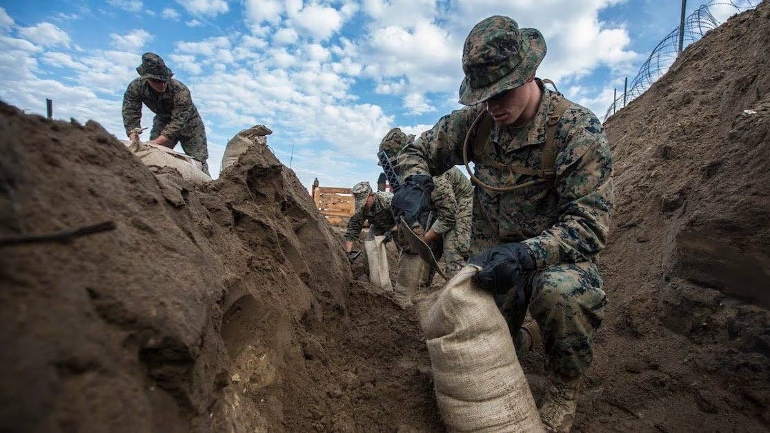 Marines assigned to Marine Wing Support Squadron 271, Marine Aircraft Group 14, 2nd Marine Aircraft Wing fill sand bags during a field exercise aboard Marine Corps Auxiliary Landing Field Bogue, N.C., Nov. 30, 2016. MWSS-271 conducted a two-week field exercise that focused on maintaining the squadron's expeditionary mindset and included an evaluation by the Marine Corps Combat Readiness Evaluation system. (U.S. Marine Corps photo by Sgt. N.W. Huertas/ Released)