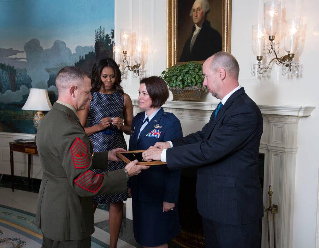 First Lady Michelle Obama participates in a promotion ceremony for Col. Nichole Malachowski in the Diplomatic Reception Room of the White House, Sept. 16, 2015. (Official White House Photo by Chuck Kennedy)
This photograph is provided by THE WHITE HOUSE as a courtesy and may be printed by the subject(s) in the photograph for personal use only. The photograph may not be manipulated in any way and may not otherwise be reproduced, disseminated or broadcast, without the written permission of the White House Photo Office. This photograph may not be used in any commercial or political materials, advertisements, emails, products, promotions that in any way suggests approval or endorsement of the President, the First Family, or the White House.