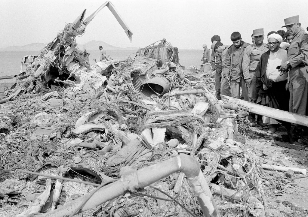 Senior Iranian officials look over burned-out equipment left by US forces after their failed rescue mission, April 27, 1980. AP Photo