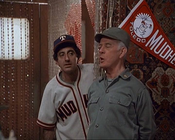 Farr on “M*A*S*H*” with Harry Morgan supporting his team the Toledo Mud Hens. Photo credit IMDB.com.
