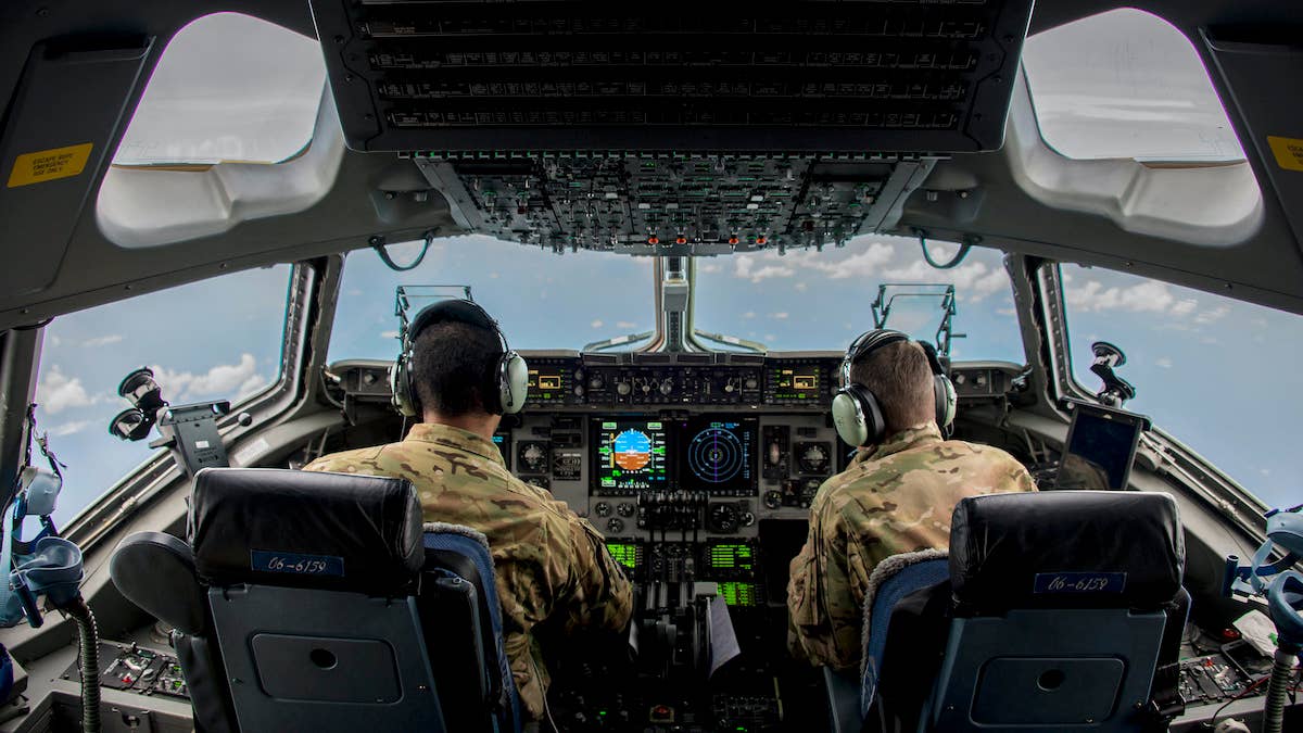 Capt. Bryan Adams, left, and Capt. David Wilfong, 15th Airlift Squadron pilots, fly a C-17 Globemaster III enroute to Puerto Rico, Sept. 9, 2017, to deliver personnel and equipment in support of Hurricane Irma relief operations. (U.S. Air Force photo by Staff Sgt. Charles Rivezzo)