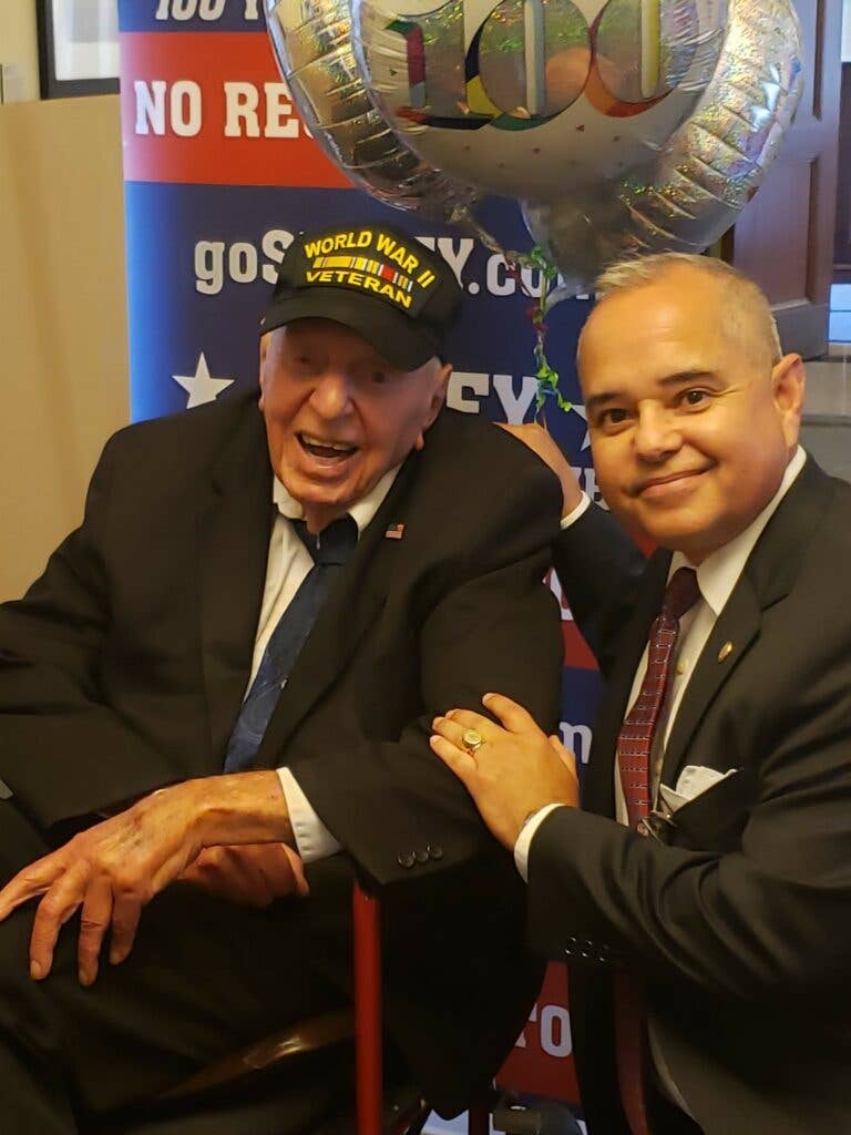Vasquez with World War II veteran Sidney Walton on his 100th birthday