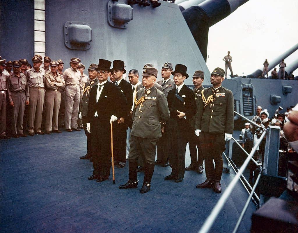 Representatives of the Empire of Japan stand aboard USS Missouri prior to signing of the Instrument of Surrender. (Photograph from the Army Signal Corps Collection in the U.S. National Archives)