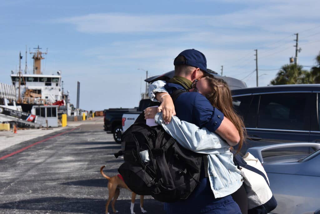 Photo of loved ones reuniting after deployment