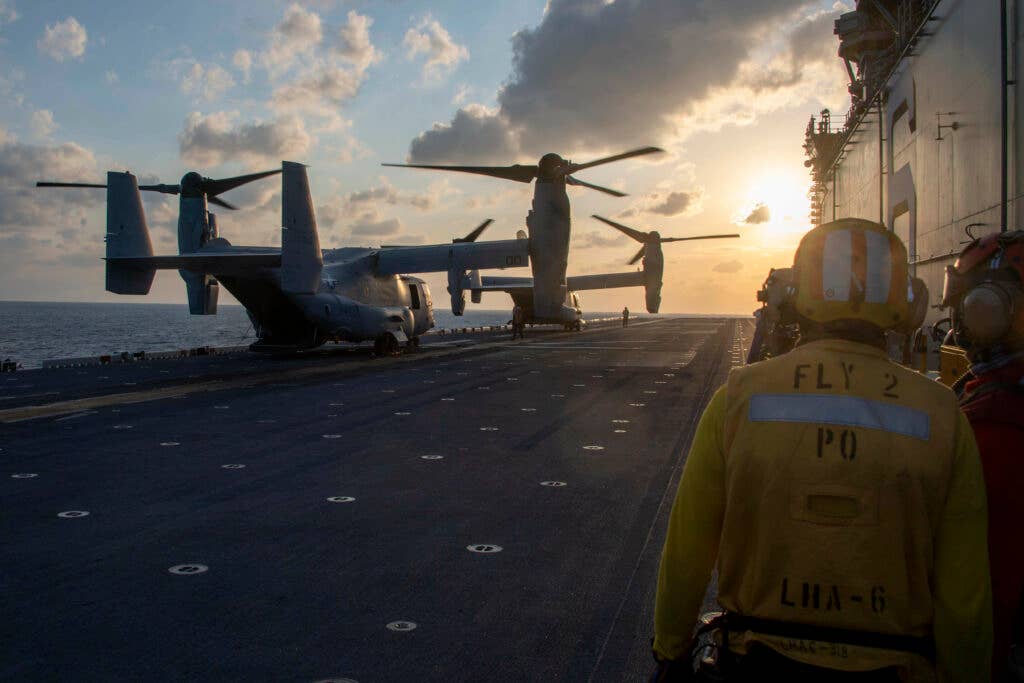 PHILIPPINE SEA (Jan. 14, 2021) Two MV-22B Ospreys assigned to the 31st Marine Expeditionary Unit prepare to launch from the flight deck of the forward-deployed amphibious assault ship USS America (LHA 6). America, lead ship of the America Amphibious Ready Group, along with the 31st MEU, is operating in the U.S. 7th Fleet area of responsibility to enhance interoperability with allies and partners and serve as a ready response force to defend peace and stability in the Indo-Pacific region. (U.S. Navy photo by Mass Communication Specialist Seaman Theodore C. Lee)