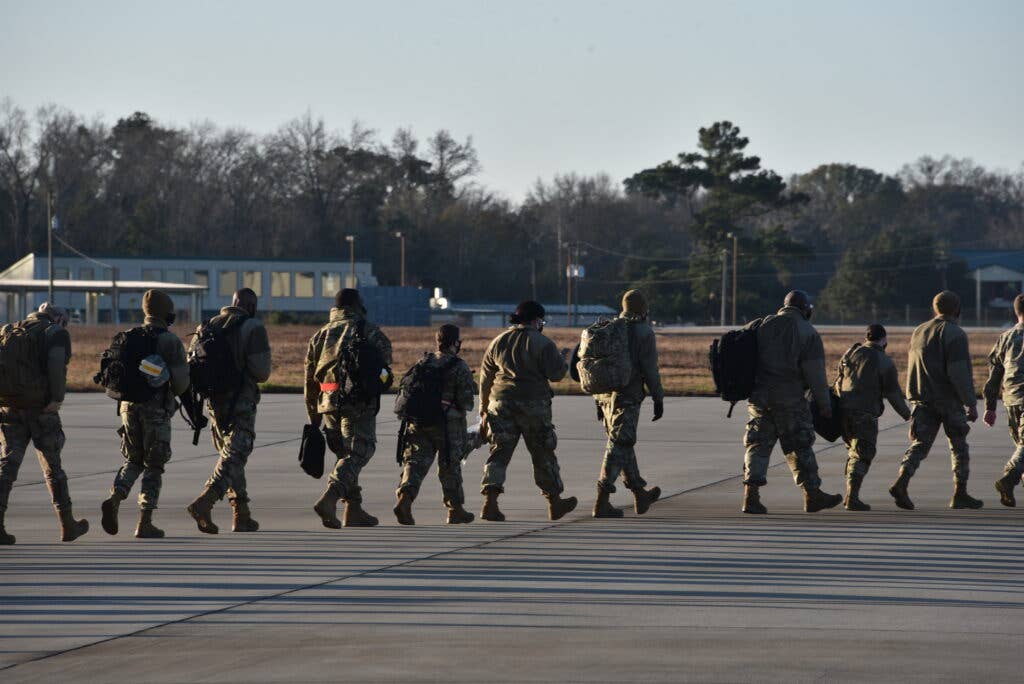 U.S. Air Force Airmen walk to a C-130 on the flight line of the 165th Airlift Wing, Savannah, Georgia, Jan. 16, 2021 before flying to D.C. to support the upcoming 59th Presidential Inauguration Jan. 20. The Georgia Air National Guard will be assisting federal and district authorities. (U.S. Air National Guard photo by Amber Williams)