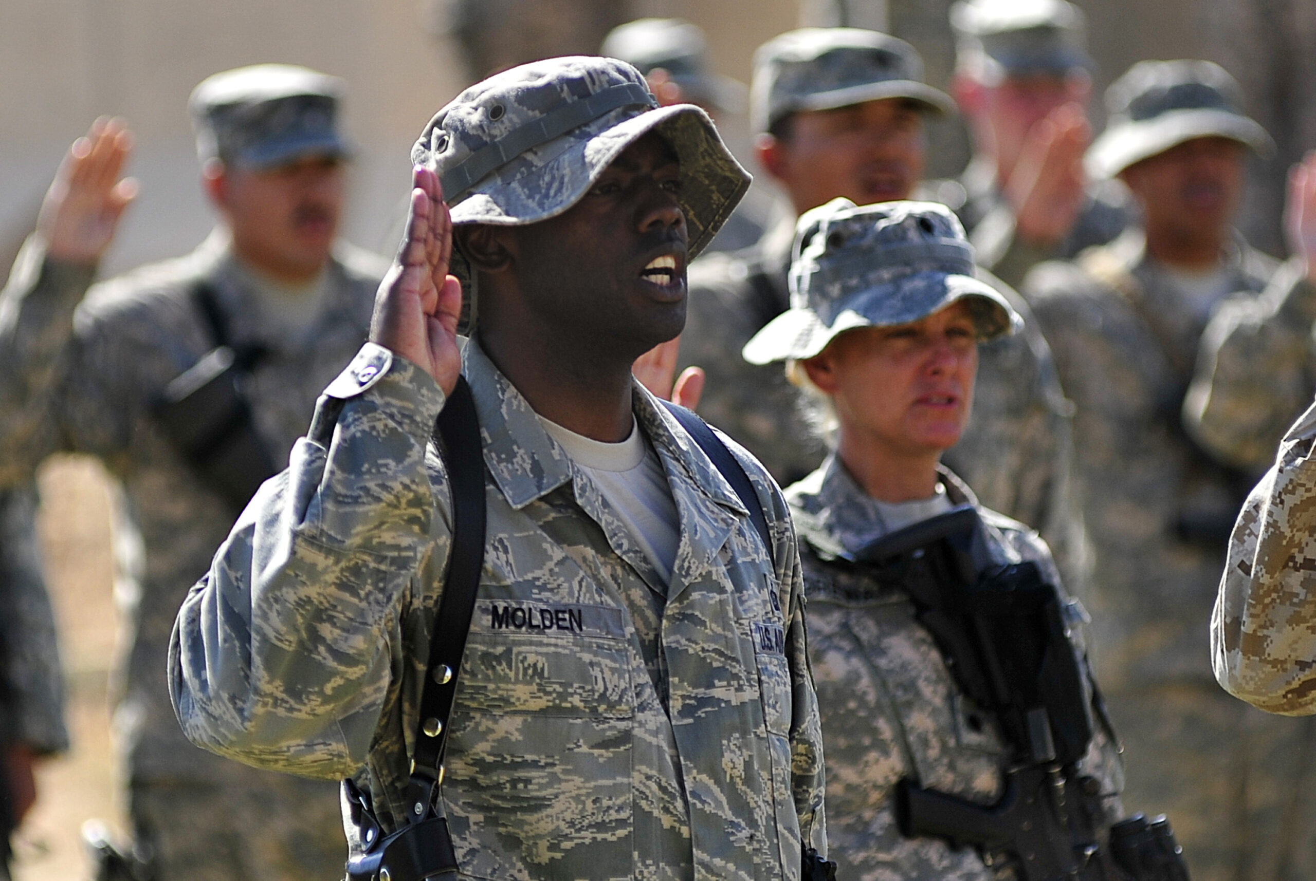 Tech. Sgt. LaMarcus Molden, 9th Air and Space Expeditionary Task Force-Iraq personnel manager, recites the oath of enlistment along with 125 other service members during a re-enlistment ceremony at Al Asad Air Base, Iraq, Oct. 5, 2011. Molden is deployed from Ramstein Air Base, Germany, and is from Albany, Ga.