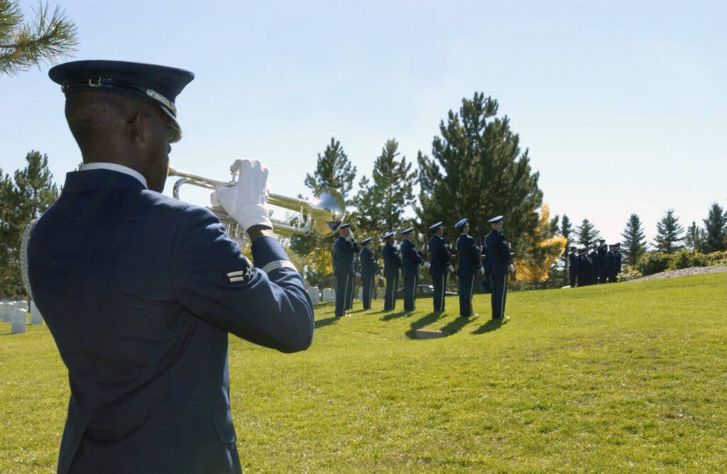 A Buckley Air Force Base Honor Guard bugler plays taps at the funeral for World War II flying ace, retired Col. John Smith Stewart at the Ft. Logan National Cemetery, Denver, Colo., on Oct. 8. 2004. (U.S. Air Force Photo by Staff Sgt. Anika Williams) (RELEASED)