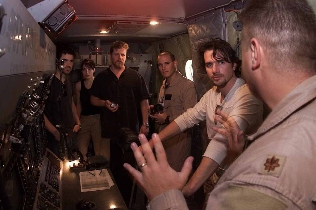 Cast members from the Home Box Office (HBO) World War II mini-series "Band of Brothers" are given a tour of an aircraft by US Air Force (USAF) personnel at an undisclosed location.  Cast members are part of a United Service OrganizationÕs (USO) tour visiting deployed troops overseas.