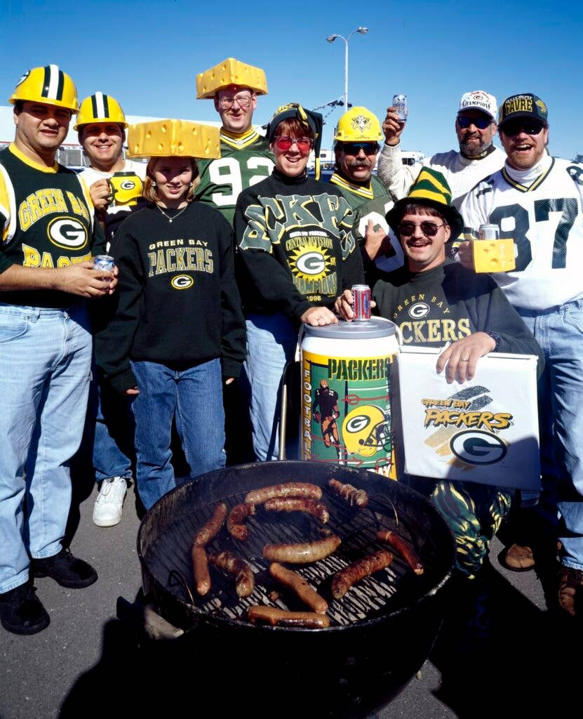 Fans in NFL merchandise, cheering on the Green Bay Packers