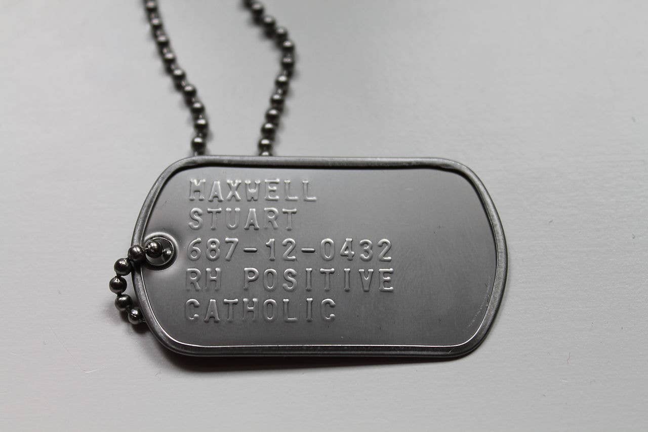 An American dog tag showing the recipient's last name, first name, Social Security number, blood type, and religion. (Wikimedia Commons)