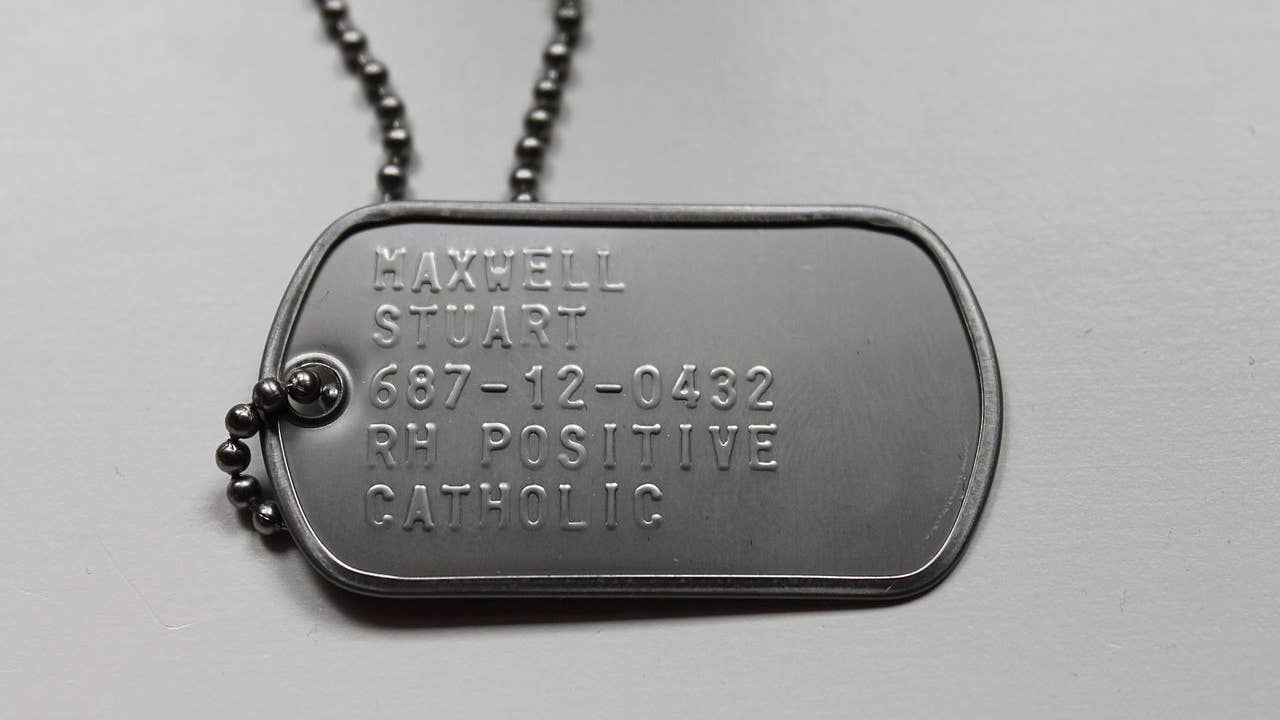 An American dog tag showing the recipient's last name, first name, Social Security number, blood type, and religion. (Wikimedia Commons)