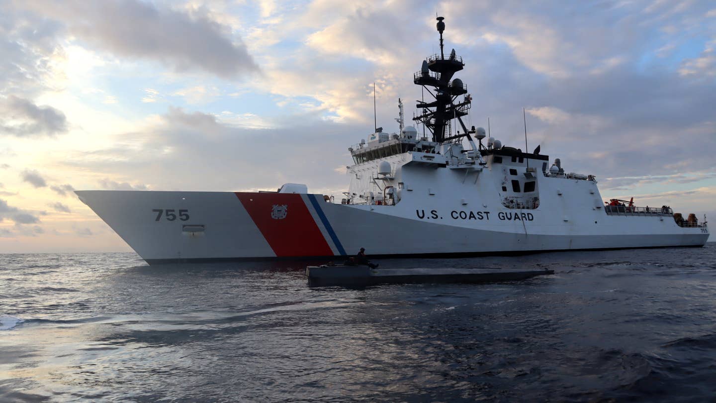 Coast Guard Cutter Munro (WMSL 755) boarding team member sits atop an interdicted low-profile vessel in the Eastern Pacific Ocean after crews seized 3,439 pounds of cocaine from the LPV, Jan. 27, 2021. Munro is one of two Alameda, California-based cutters who's crews interdicted a combined three suspected drug smuggling vessels in the Eastern Pacific Ocean between Jan. 26 and Feb. 1 resulting in the seizure of more than 9,000 pounds of cocaine worth an estimated $156 million. U.S. Coast Guard photo courtesy of the Coast Guard Cutter Munro.
