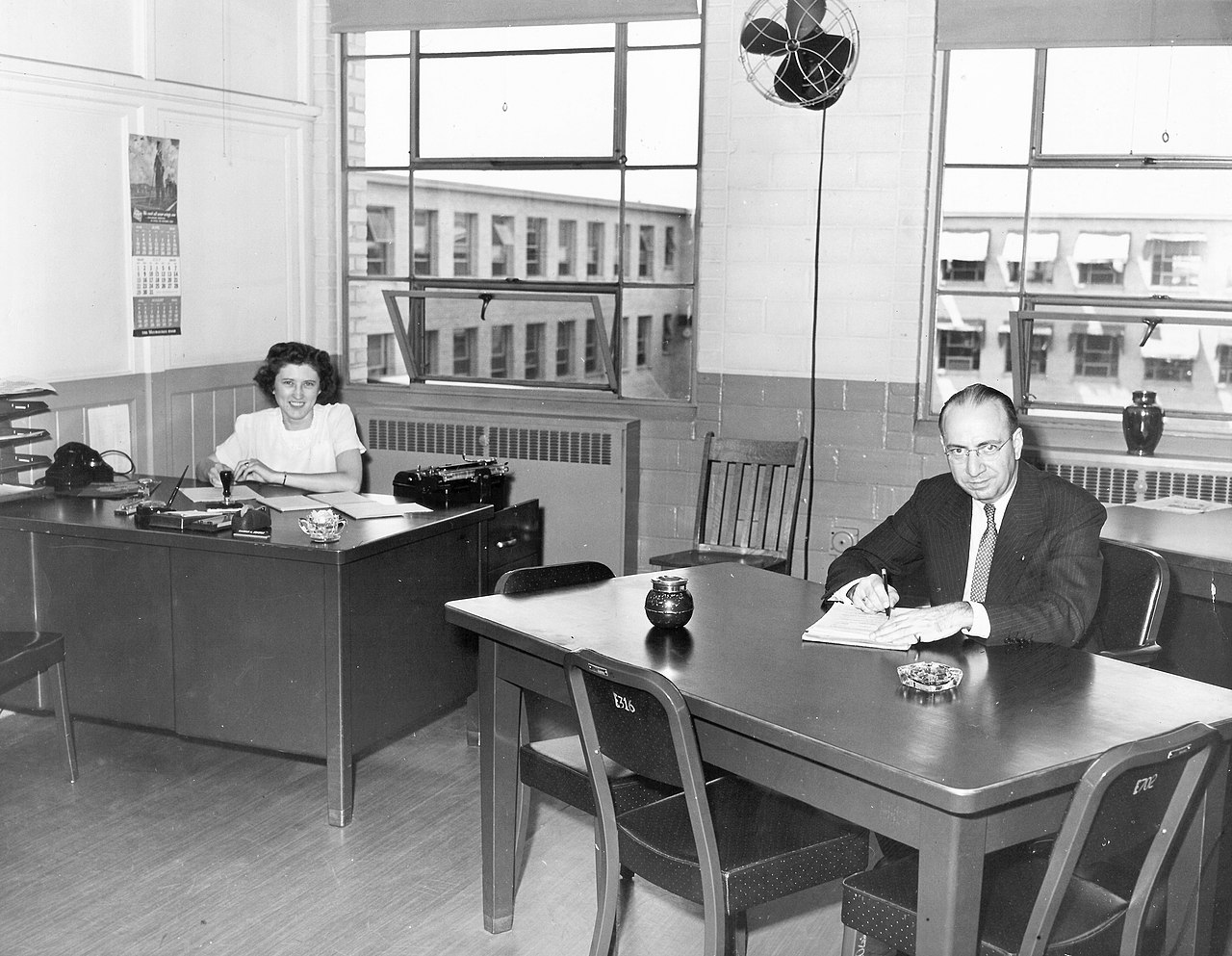 "Office of the Commanding Officer, Twin Cities Ordnance Plant, St. Paul, - Minneapolis", Minnesota. Shows office at Twin Cities Ordnance Plant that was located in New Brighton, Minnesota during World War II. The man seated at desk is "engineering manager" Raymond M. Winslow. (Wikipedia)